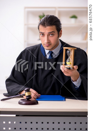 Young male judge in time management concept Young male judge in time management concept 68576470