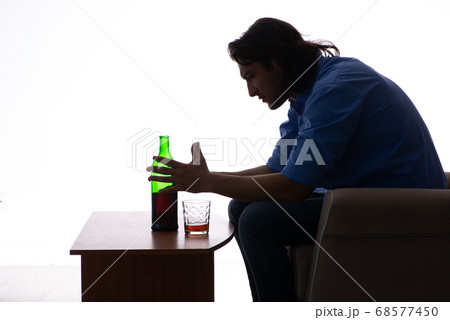 Young man suffering from alcoholism Young man suffering from alcoholism 68577450