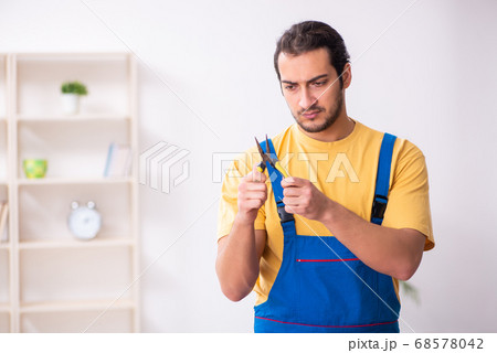 Young male carpenter working indoors Young male carpenter working indoors 68578042