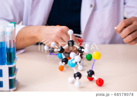 Young male scientist sitting in the classroom Young male scientist sitting in the classroom 68578078