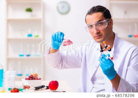 Young male nutrition expert testing food products in lab Young male nutrition expert testing food products in lab 68578206