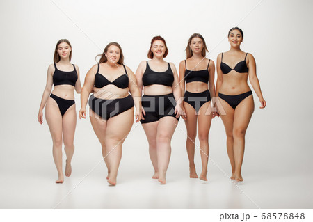 Portrait of beautiful young women with different shapes posing on white background 68578848