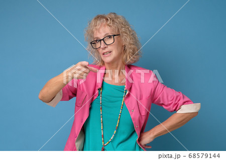 Woman frowning pointing index finger at camera, blaming you in all her problems. 68579144