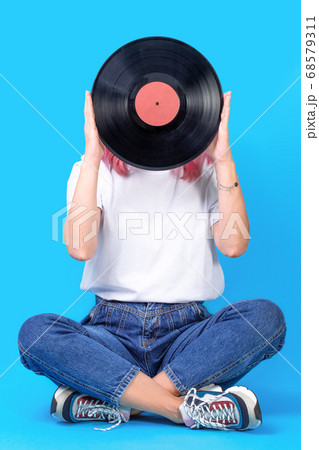 Woman dj portrait with vinyl record against blue background. 68579311