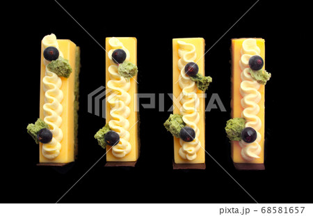 Orange mousse and pistachio sponge cake slices 68581657