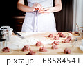 woman makes dumplings at home on kitchen table, close up 68584541
