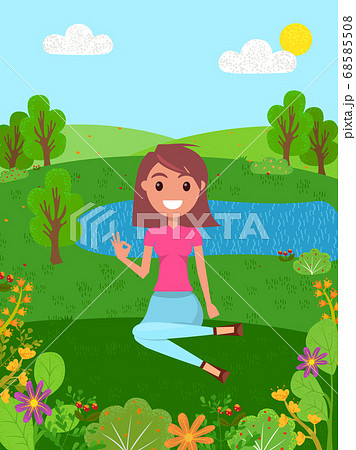 Young smiling girl sits on a grass and shows okay. Forest background with a river. Flat image Young smiling girl sits on a grass and shows okay. Forest background with a river. Flat image 68585508