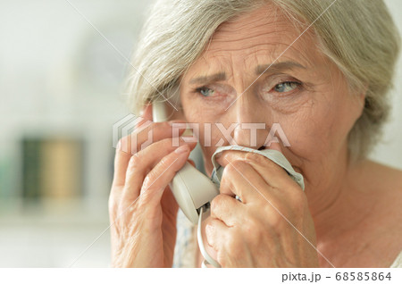 Portrait of upset senior woman calling doctor Portrait of upset senior woman calling doctor 68585864