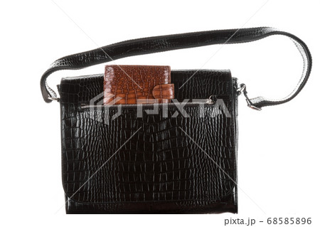 Brown wallet in the pocket of a man's black bag. 68585896