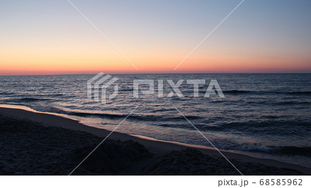 Sunset on Baltic Sea. Waves on seashore in evening Sunset on Baltic Sea. Waves on seashore in evening 68585962