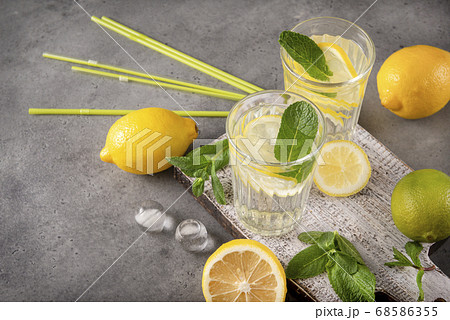 glasses of lemonade with yellow lemon and mint on 68586355