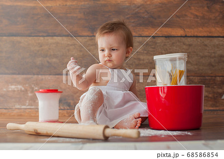 Little baby chef in apron. 68586854