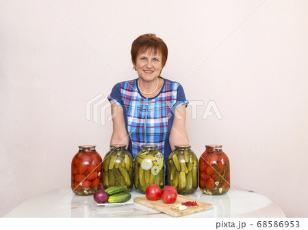 woman in blue plaid tunic in the kitchen next to 68586953