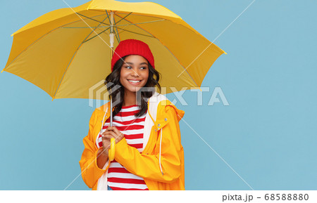 Happy ethnic female under bright umbrella. Happy ethnic female under bright umbrella. 68588880