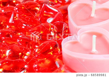 pink candles in the form of a heart on a red background for Valentine's day pink candles in the form of a heart on a red background for Valentine's day 68589981