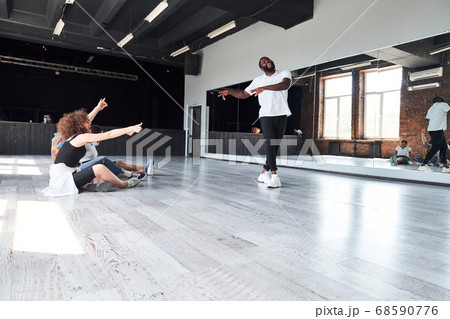 Merry young people learning modern dances in studio 68590776