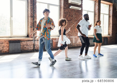 Jolly young people enjoying dancing together indoors 68590806