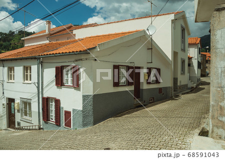 Alley and old houses with plaster wall 68591043