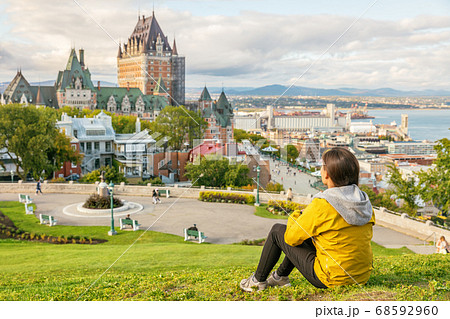 Canada travel Quebec city tourist enjoying view of Chateau Frontenac castle and St. Lawrence river in background. Autumn traveling holiday people lifestyle 68592960