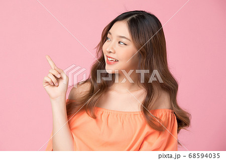 ピンクのBGの前でポーズする可愛い女性 ピンクのBGの前でポーズする可愛い女性 68594035