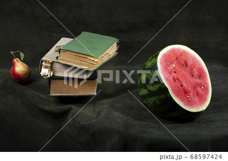 Still life with pear, watermelon and books 68597424