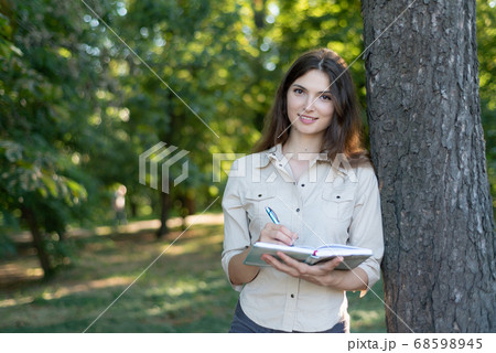 Young beautiful girl student in shirt by day 68598945