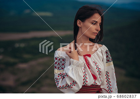 Atractive woman in traditional romanian costume on Atractive woman in traditional romanian costume on 68602837