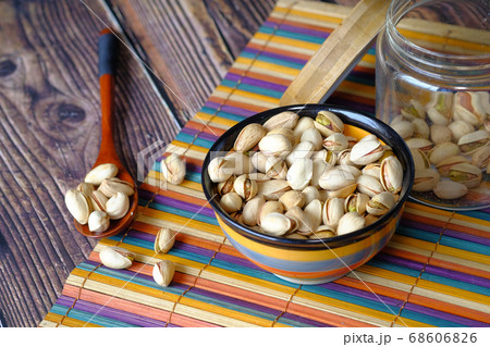 salted pistachios nut in a jar on table cloth. salted pistachios nut in a jar on table cloth. 68606826