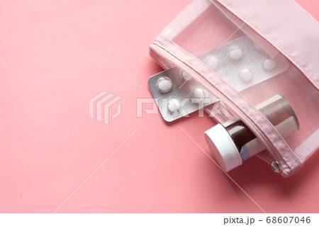 Top view of pill container and blister pack on pink Top view of pill container and blister pack on pink 68607046
