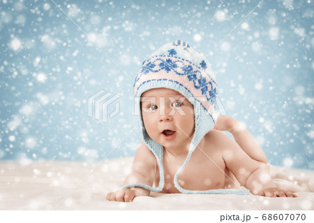 Eight month old baby lying on soft blanket Eight month old baby lying on soft blanket 68607070