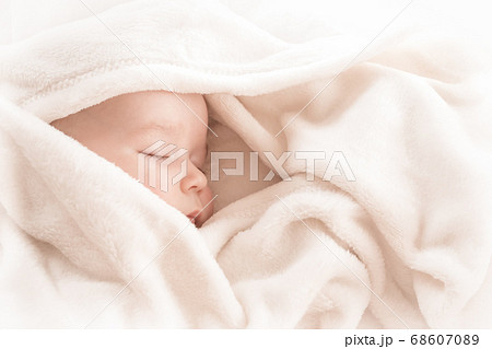 Baby sleeping covered with soft white blanket Baby sleeping covered with soft white blanket 68607089