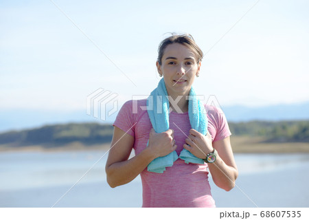 young sporty woman with blue towel in the 68607535