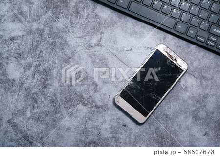 Top view of broken smart phone on table. 68607678
