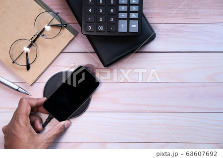 charging Smartphone Using Wireless Charging Pad, top view charging Smartphone Using Wireless Charging Pad, top view 68607692