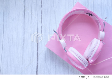 Top view of headphone on a book on table . Top view of headphone on a book on table . 68608488