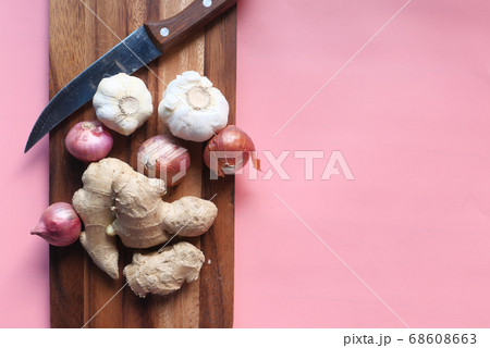 ginger, garlic and onion on chopping board. ginger, garlic and onion on chopping board. 68608663