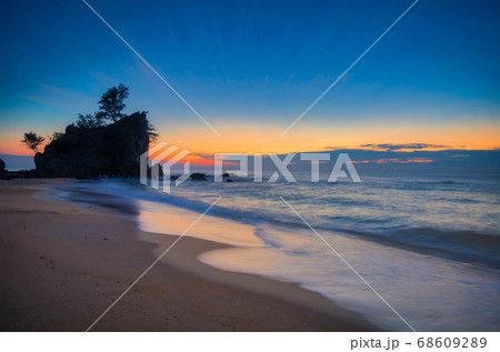 sunrise at tropical beach against golden sky and cloud balckground sunrise at tropical beach against golden sky and cloud balckground 68609289
