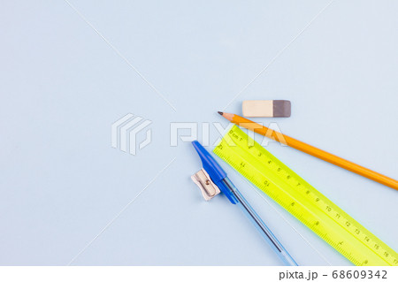 Office supplies on a light blue background. 68609342