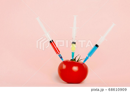 Tomato and syringes with toxins 68610909