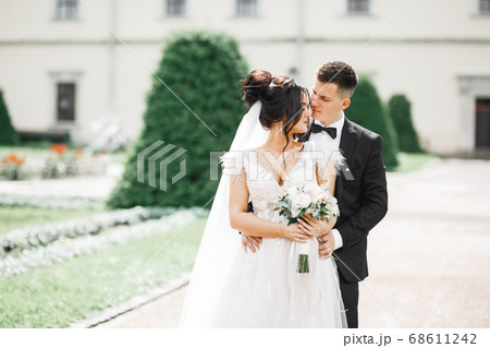 Romantic wedding moment, couple of newlyweds smiling portrait, bride and groom hugging 68611242