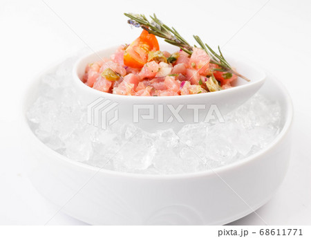 fresh tuna tartar on a pillow of ice on a white 68611771