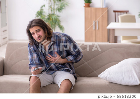 Young man suffering at home 68613200