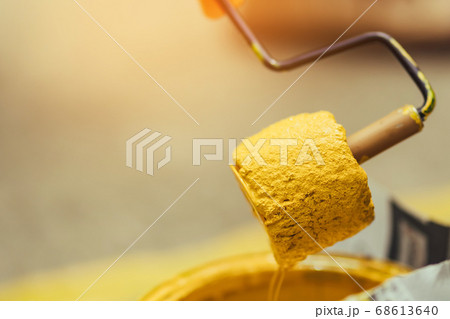 Male students use small paint rollers to paint yellow lines on the cement floor for Sepak Takraw training. Male students use small paint rollers to paint yellow lines on the cement floor for Sepak Takraw training. 68613640