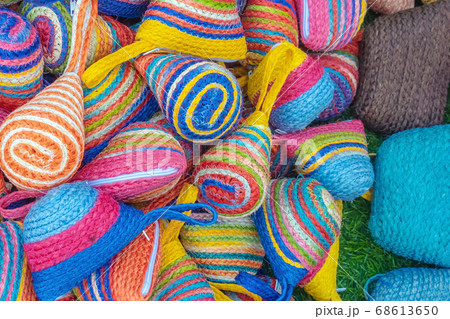 Close up to vintage handicraft colorful bags by yarn for sale at local market in Thailand. Selective focus. Close up to vintage handicraft colorful bags by yarn for sale at local market in Thailand. Selective focus. 68613650