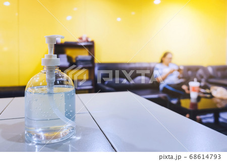 Alcohol gel bottle placed on the counter with a blurred background of the quarantine woman and resting to prevent the spread of the corona virus(Covid-19) at home.Social distancing to protect Covid-19 68614793