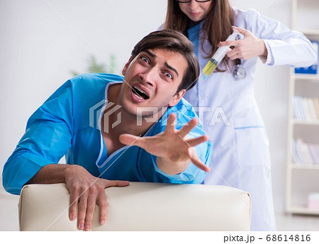 Funny man getting ready for buttocks syringe shot 68614816