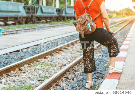 Mini portable alcohol gel bottle to kill Corona Virus(Covid-19) hang on leather shoulder bag of woman at railway staion. New normal lifestyle. Health care concept. Selective focus on alcohol gel Mini portable alcohol gel bottle to kill Corona Virus(Covid-19) hang on leather shoulder bag of woman at railway staion. New normal lifestyle. Health care concept. Selective focus on alcohol gel 68614940