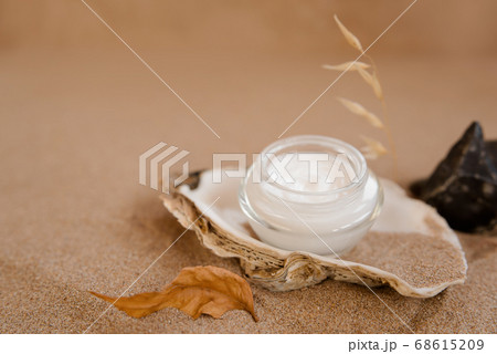 Caring cosmetics in an oyster shell on the sand. Eco-friendly organic cosmetics. 68615209