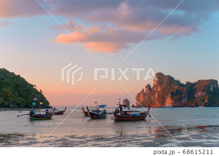 Charming sunset over a tropical island. Low tide, fishing boats. Charming sunset over a tropical island. Low tide, fishing boats. 68615211