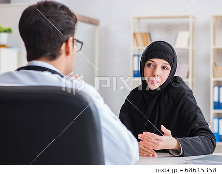 Muslim woman visiting doctor for regular check-up Muslim woman visiting doctor for regular check-up 68615358